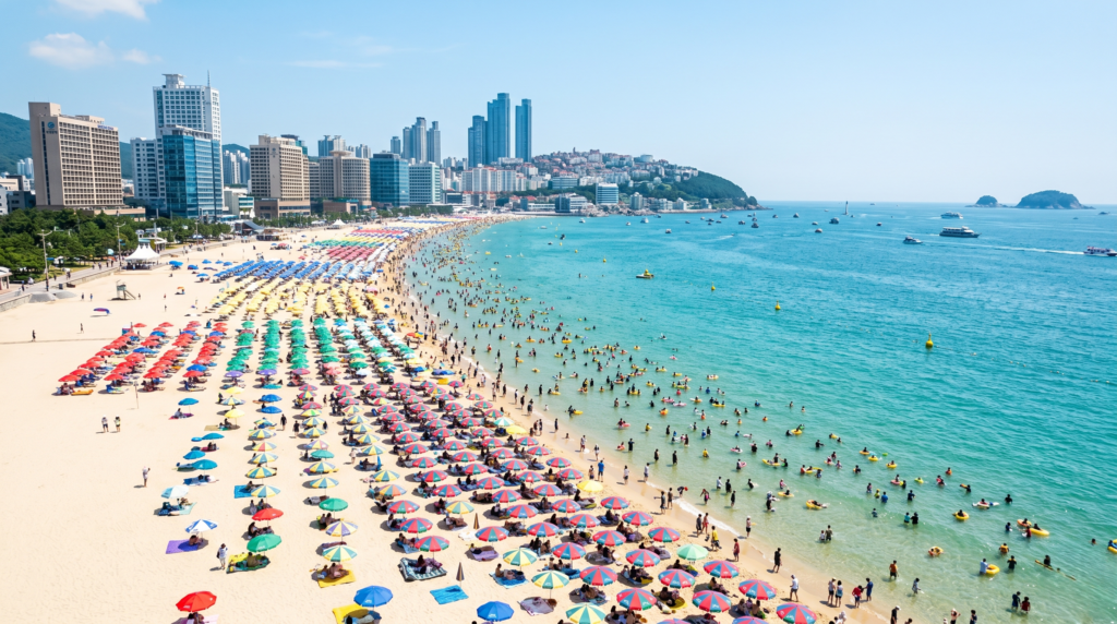 Haeundae Beach in Busan packed with colorful umbrellas and thousands of visitors on a bright August summer day